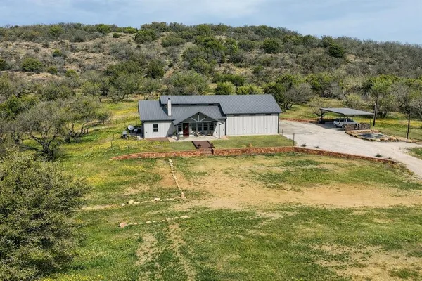 an aerial view of a houses with a yard