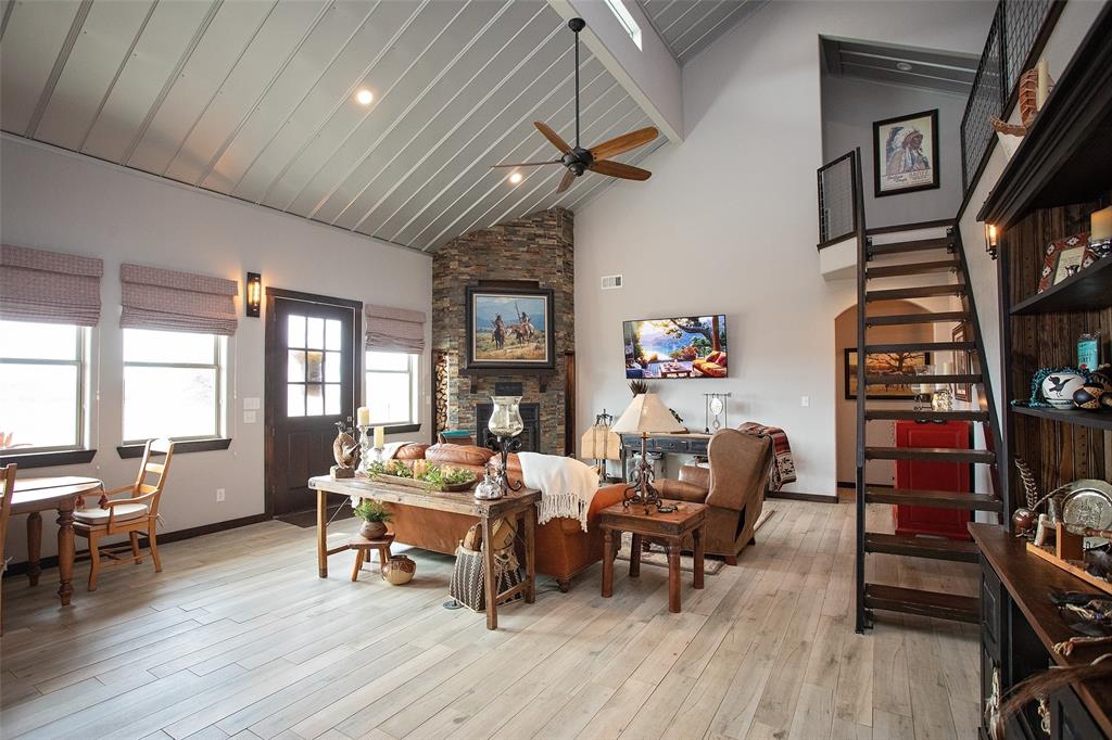 1982 Rocky Mound Road Graham, TX 76450 - Photo 6 of 35 Living room with wood burning fireplace, lofted ceiling, with recessed lighting.