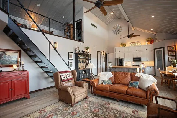 a living room with furniture and wooden floor