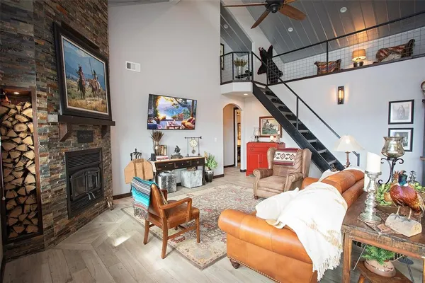 a living room with furniture a fireplace and a flat screen tv