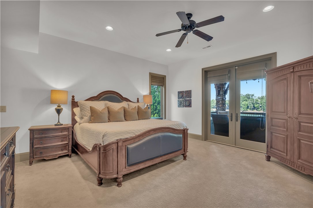 256 Talton Road Six Mile, SC 29682 - Photo 39 of 50 Plush carpeting anchors this spacious bedroom featuring recessed lighting and glass doors to the balcony.