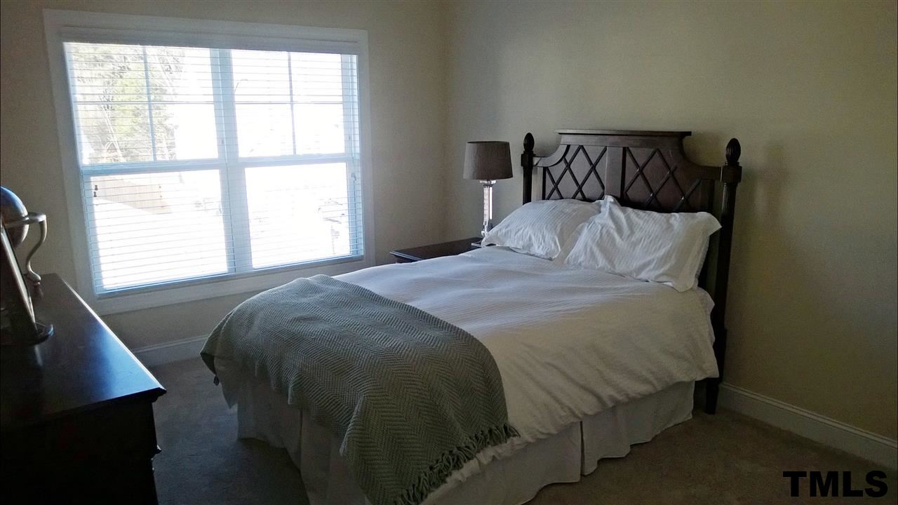 4420 Glengrove Road Raleigh, NC 27616 - Photo 22 of 25 a bed sitting in a bedroom next to a window