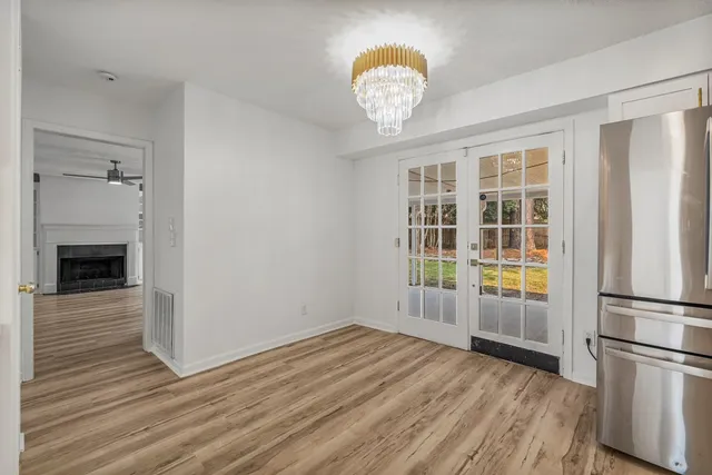a view of a kitchen with wooden floor and a kitchen space