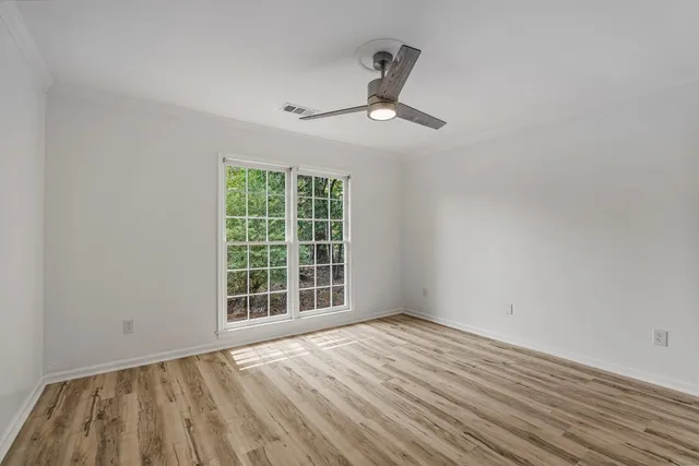 wooden floor in an empty room with a window