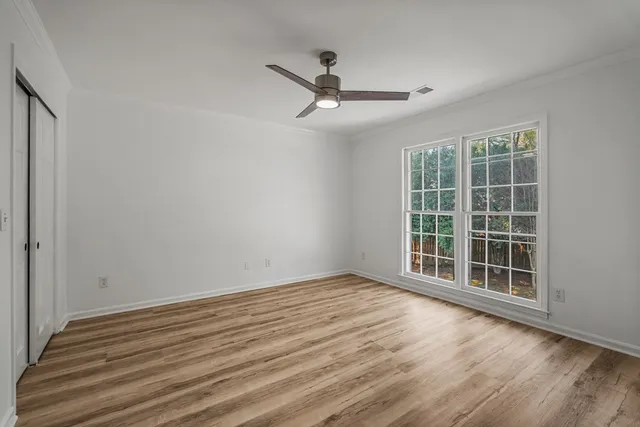 wooden floor in an empty room with a window