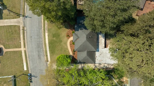 an aerial view of a house with a yard