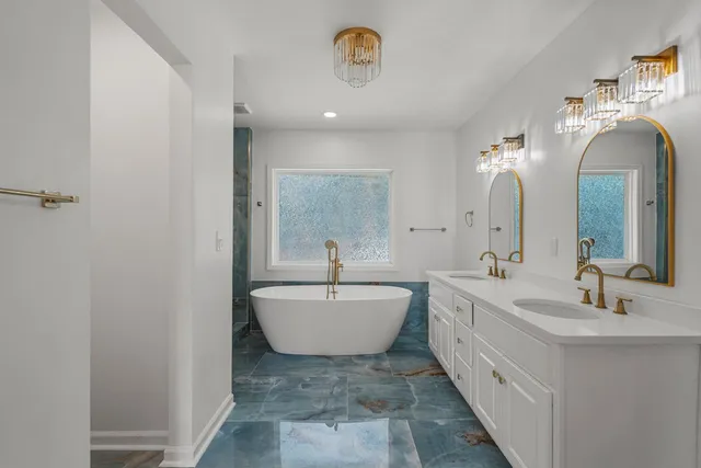 a spacious bathroom with a sink and a mirror