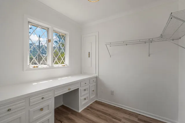 a view of cabinets with wooden floor and window
