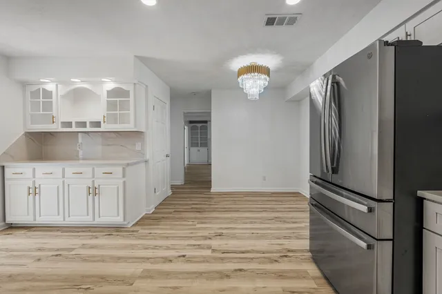 a view of a refrigerator in kitchen and wooden floor