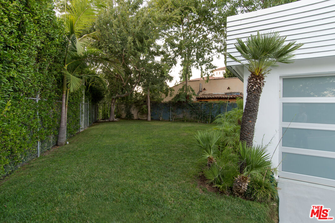 1466 Bel Air Road Los Angeles, CA 90077 - Photo 31 of 35 a front view of a house with garden