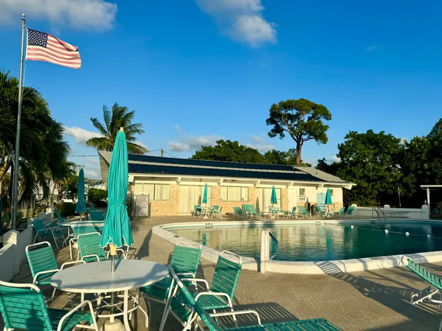 a view of a chairs and table in patio with a lake view