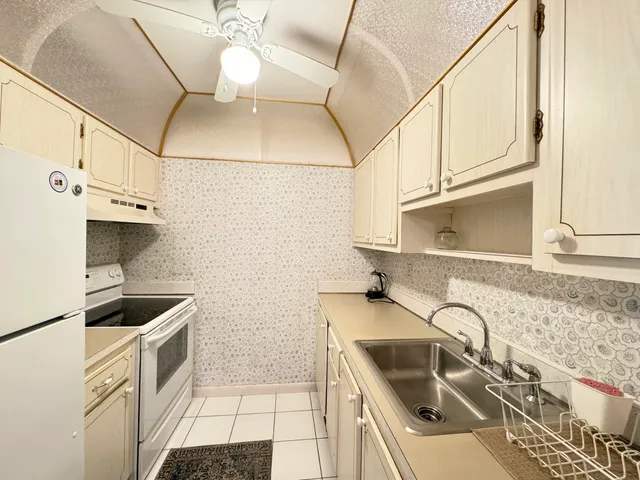 a kitchen with stainless steel appliances granite countertop a sink and cabinets
