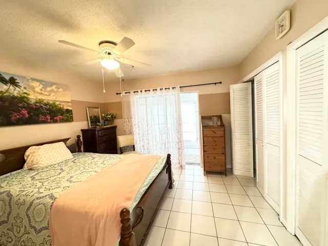 a large bedroom with a bed and a chandelier