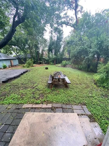 a view of a backyard with a tree
