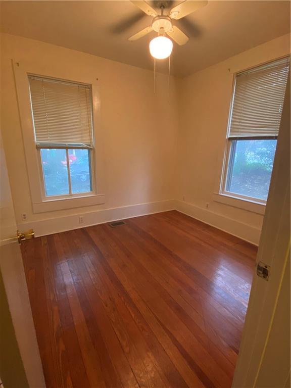 3205 Guadalupe Street, Unit A Austin, TX 78705 - Photo 7 of 17 an empty room with wooden floor and windows