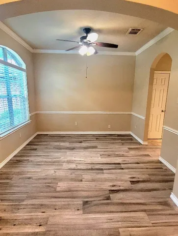 a view of a room with wooden floor and window