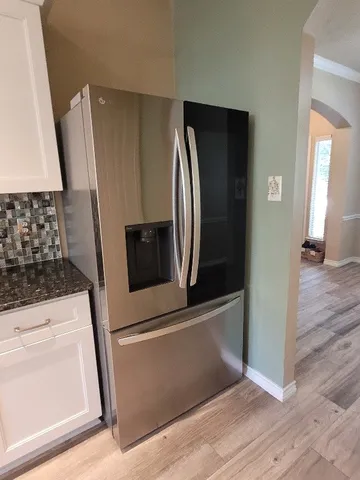 a kitchen with a cabinets and chandelier