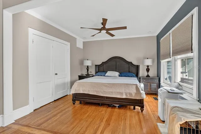 a bedroom with furniture and a wooden floor