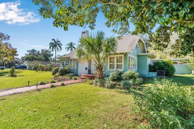 a front view of a house with garden and swimming pool