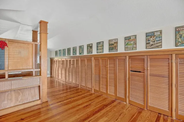 a view of a patio with table and chairs potted plants and large tree