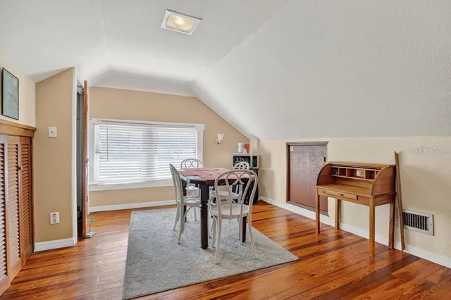 a view of a patio with a table and chairs and a barbeque