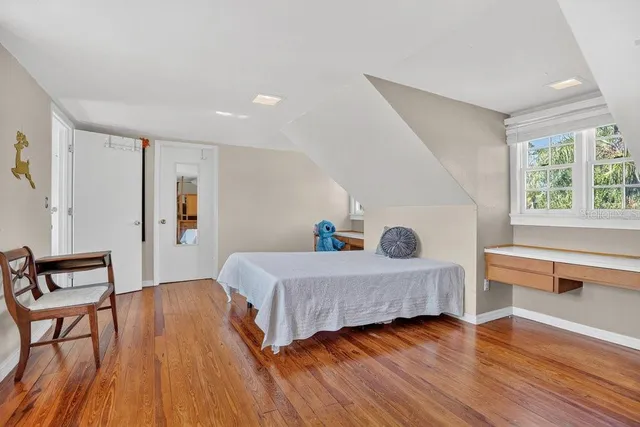 a view of a patio with table and chairs potted plants and floor to ceiling window