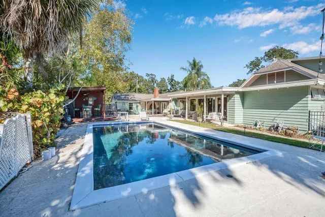 a bedroom with a bed and teddy bear on bed