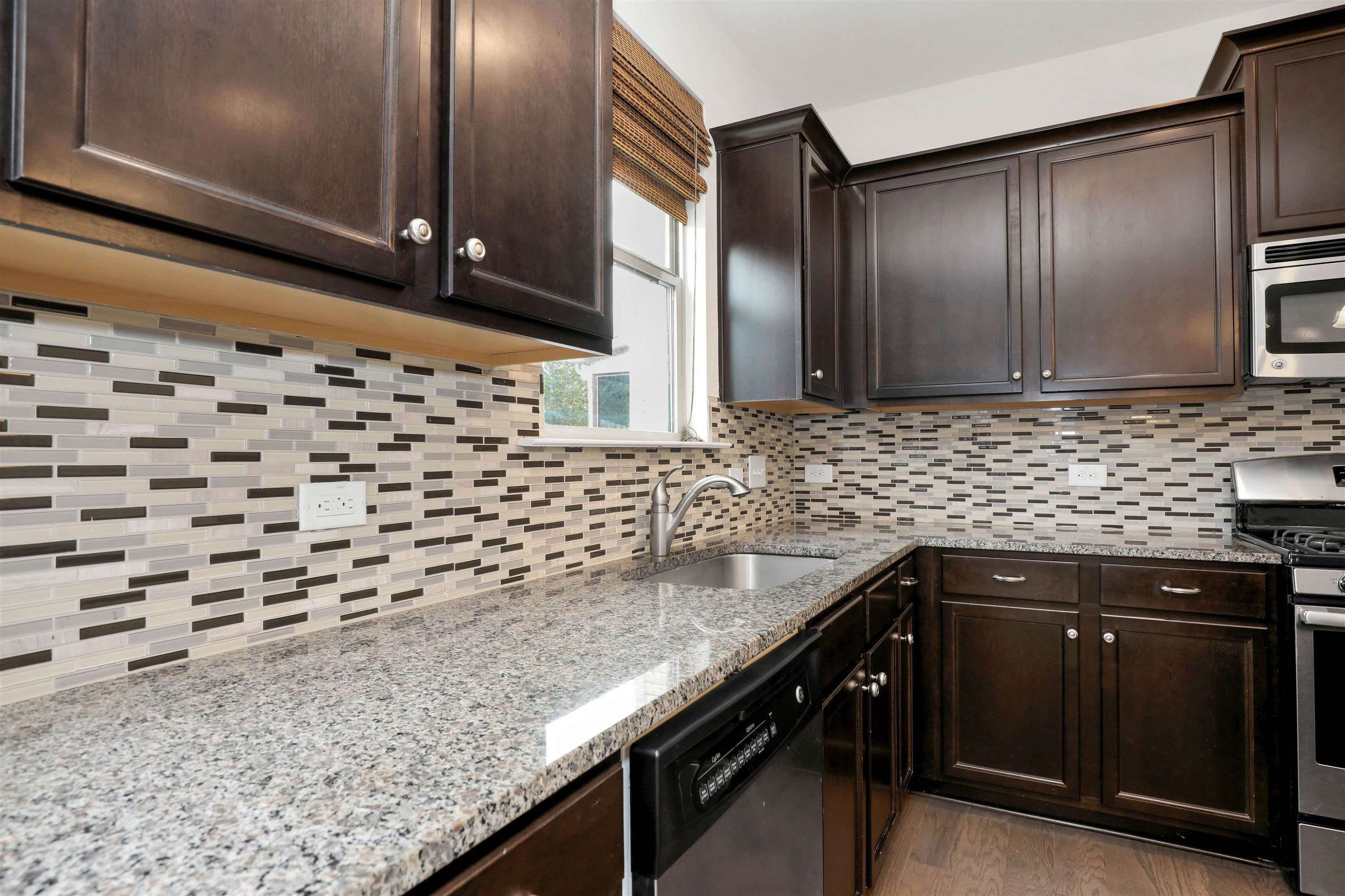 3413 Flat River Drive Durham, NC 27703 - Photo 14 of 40 a kitchen with granite countertop a sink and cabinets