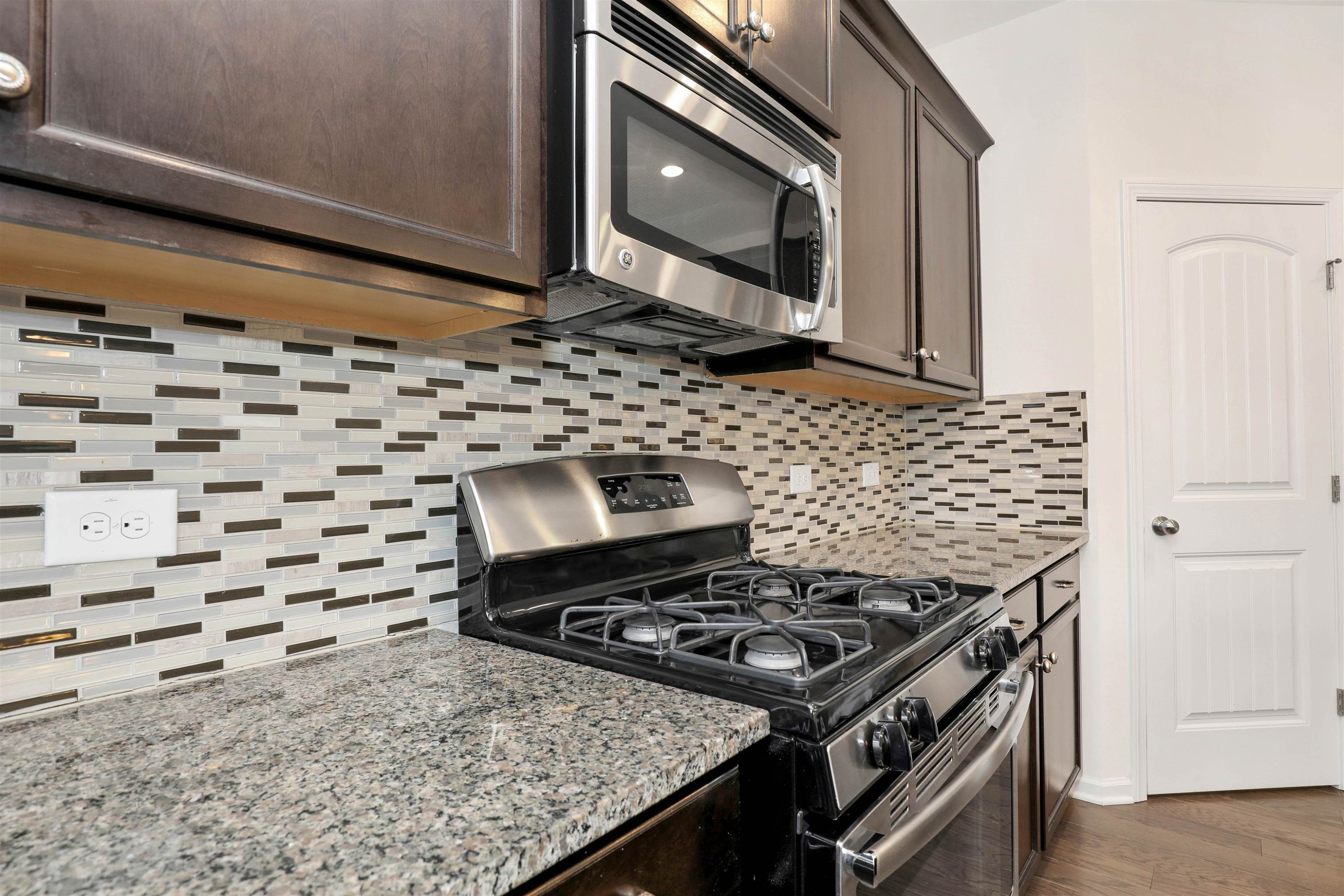 3413 Flat River Drive Durham, NC 27703 - Photo 15 of 40 a stove top oven sitting inside of a kitchen