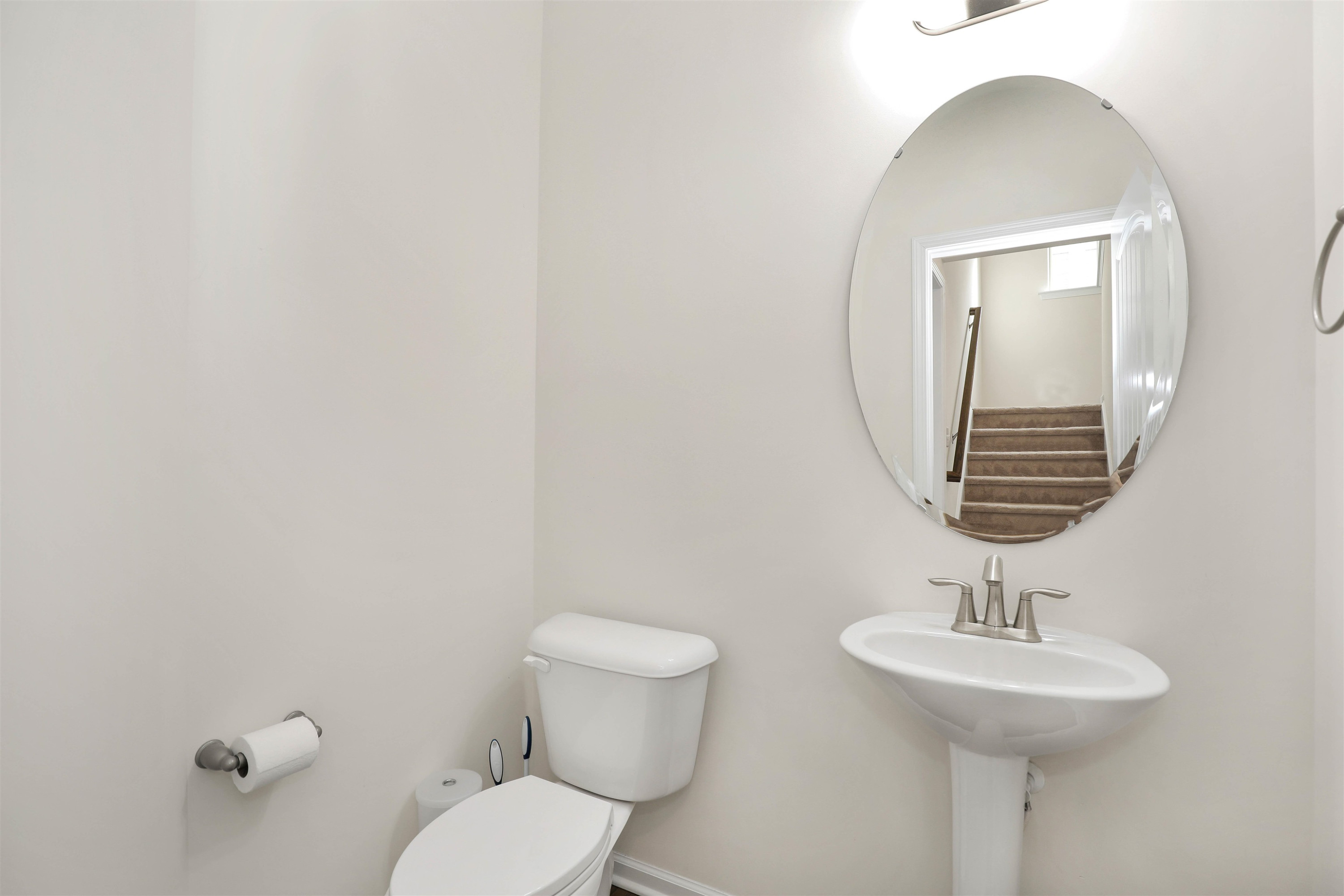 3413 Flat River Drive Durham, NC 27703 - Photo 17 of 40 a bathroom with a toilet a sink and mirror