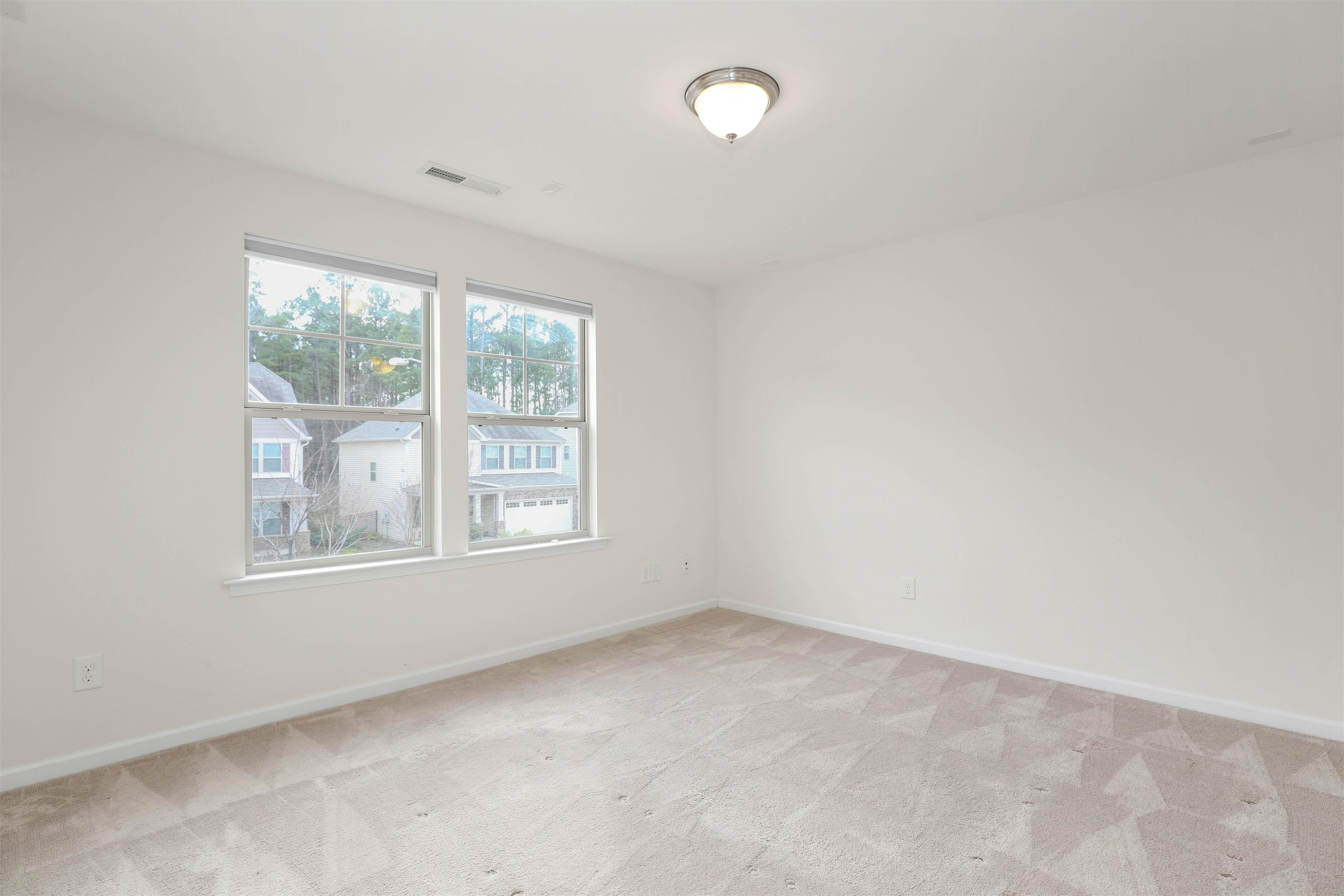 3413 Flat River Drive Durham, NC 27703 - Photo 18 of 40 an empty room with windows