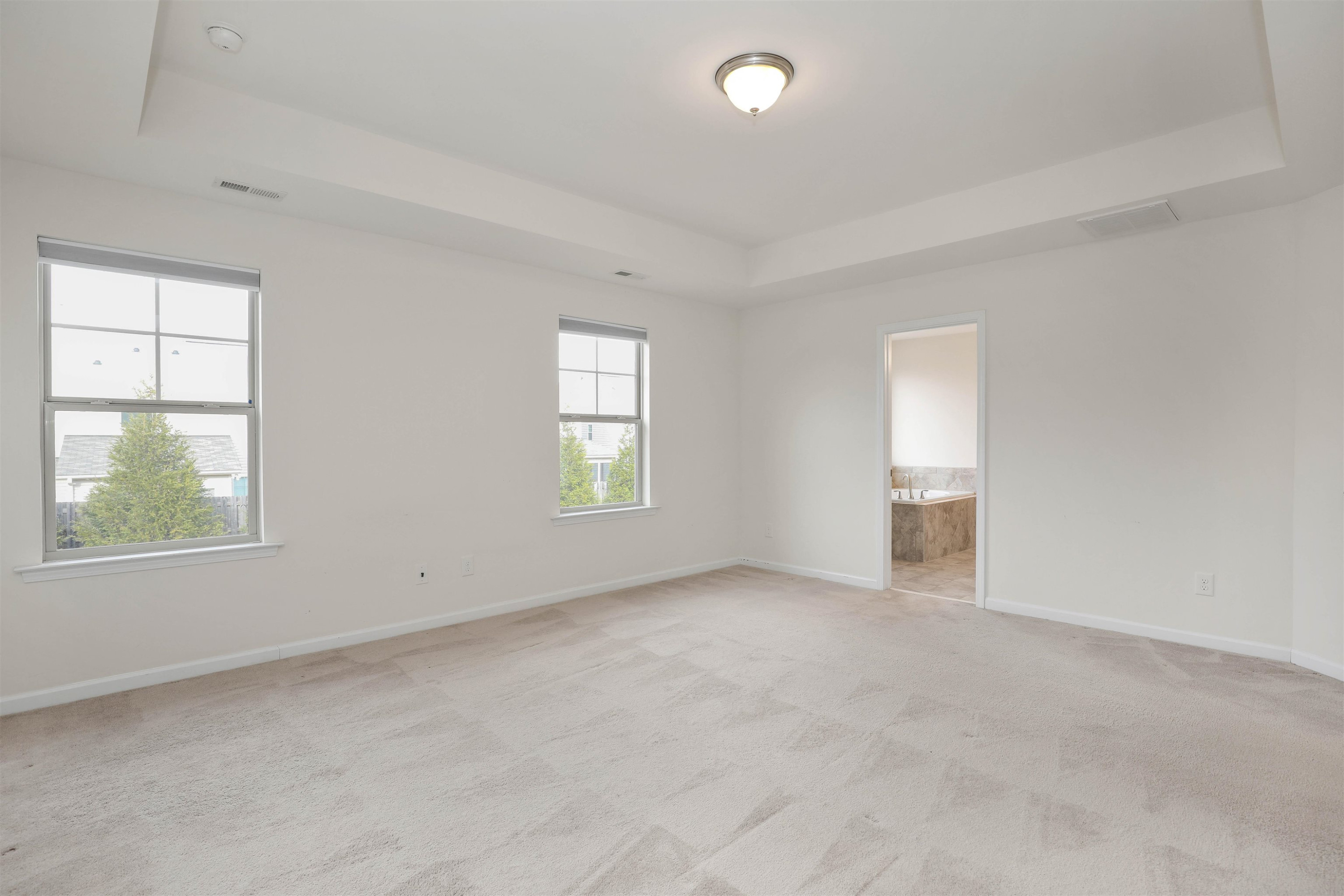 3413 Flat River Drive Durham, NC 27703 - Photo 22 of 40 an empty room with windows