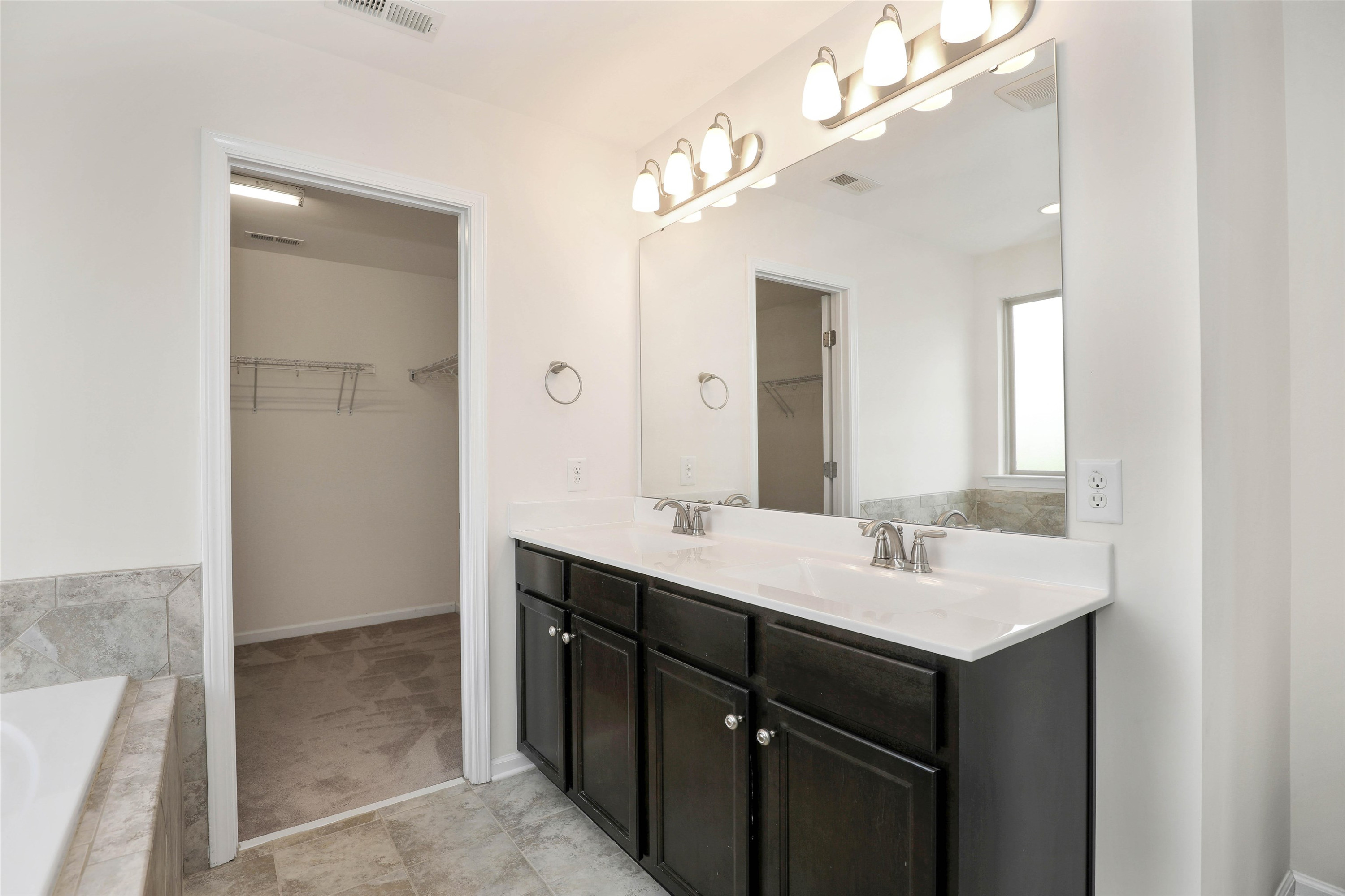 3413 Flat River Drive Durham, NC 27703 - Photo 24 of 40 a bathroom with a sink vanity and mirror