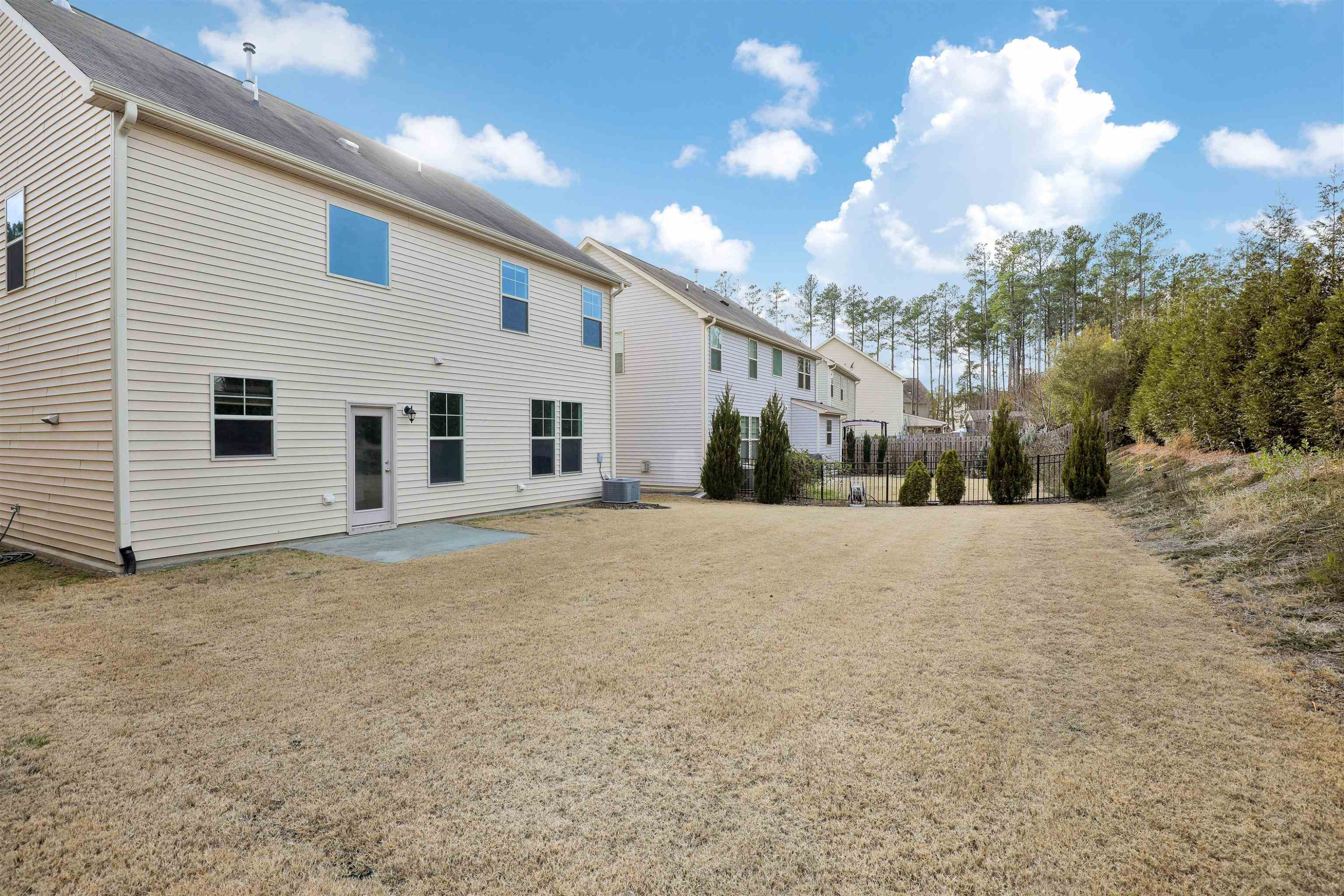 3413 Flat River Drive Durham, NC 27703 - Photo 36 of 40 a view of a white house with a yard