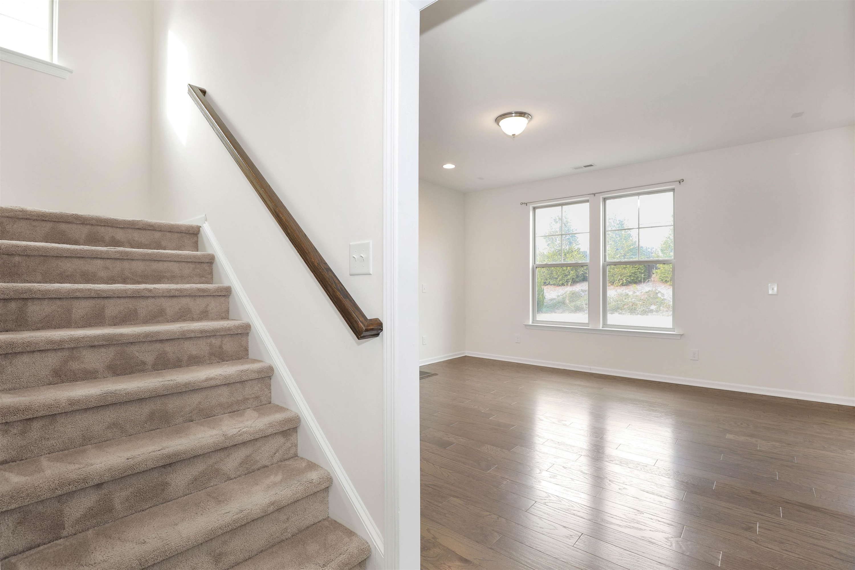 3413 Flat River Drive Durham, NC 27703 - Photo 7 of 40 a view of entryway with wooden floor and stairs