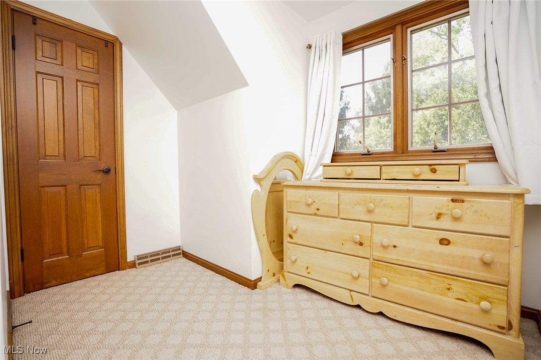 7780 Knauf Road Canfield, OH 44406 - Photo 23 of 48 Bedroom with light carpet, baseboards, and lofted ceiling