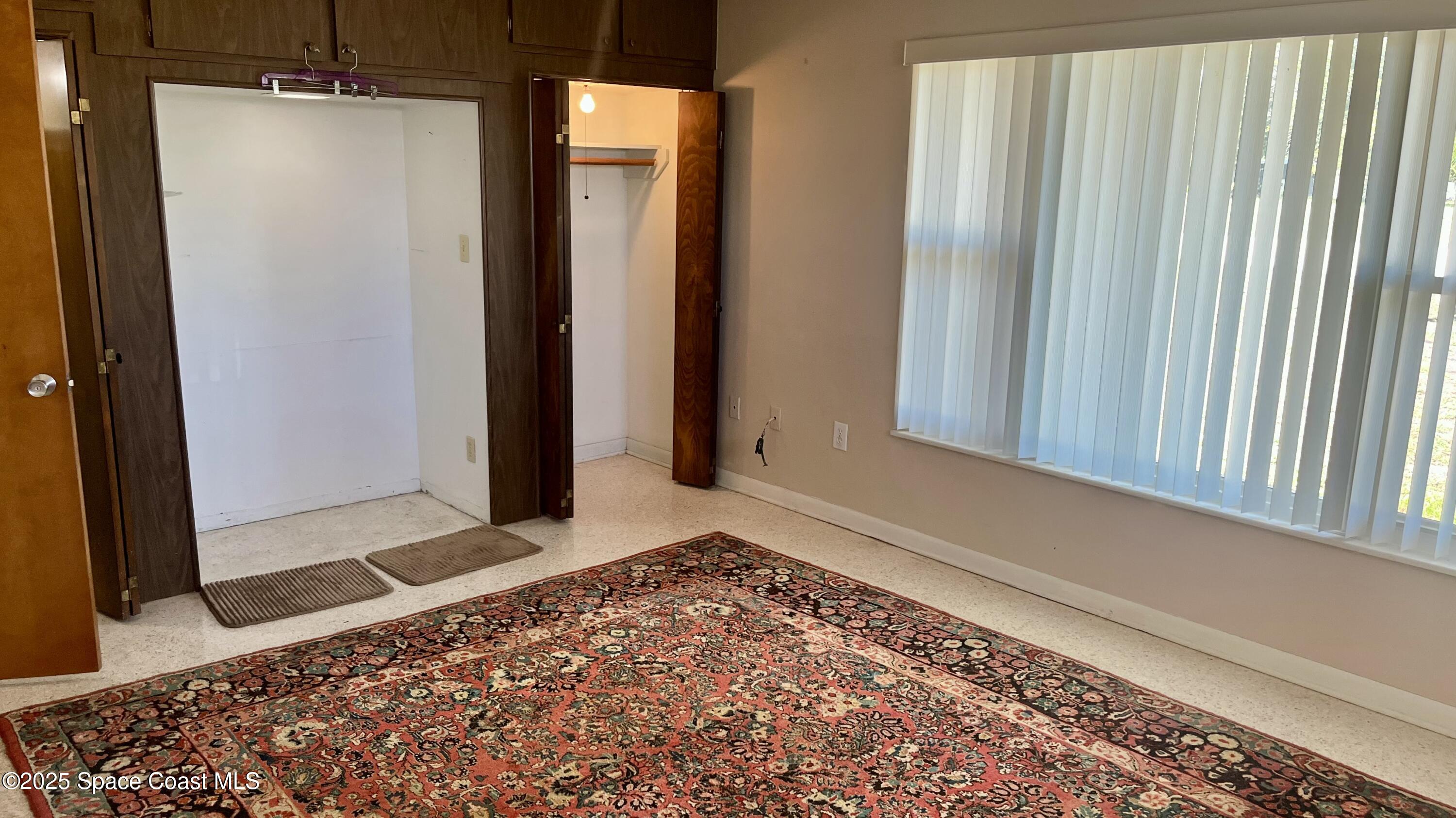 7181 Blue Shore Road Grant, FL 32949 - Photo 10 of 40 a view of an empty room with window and wooden floor
