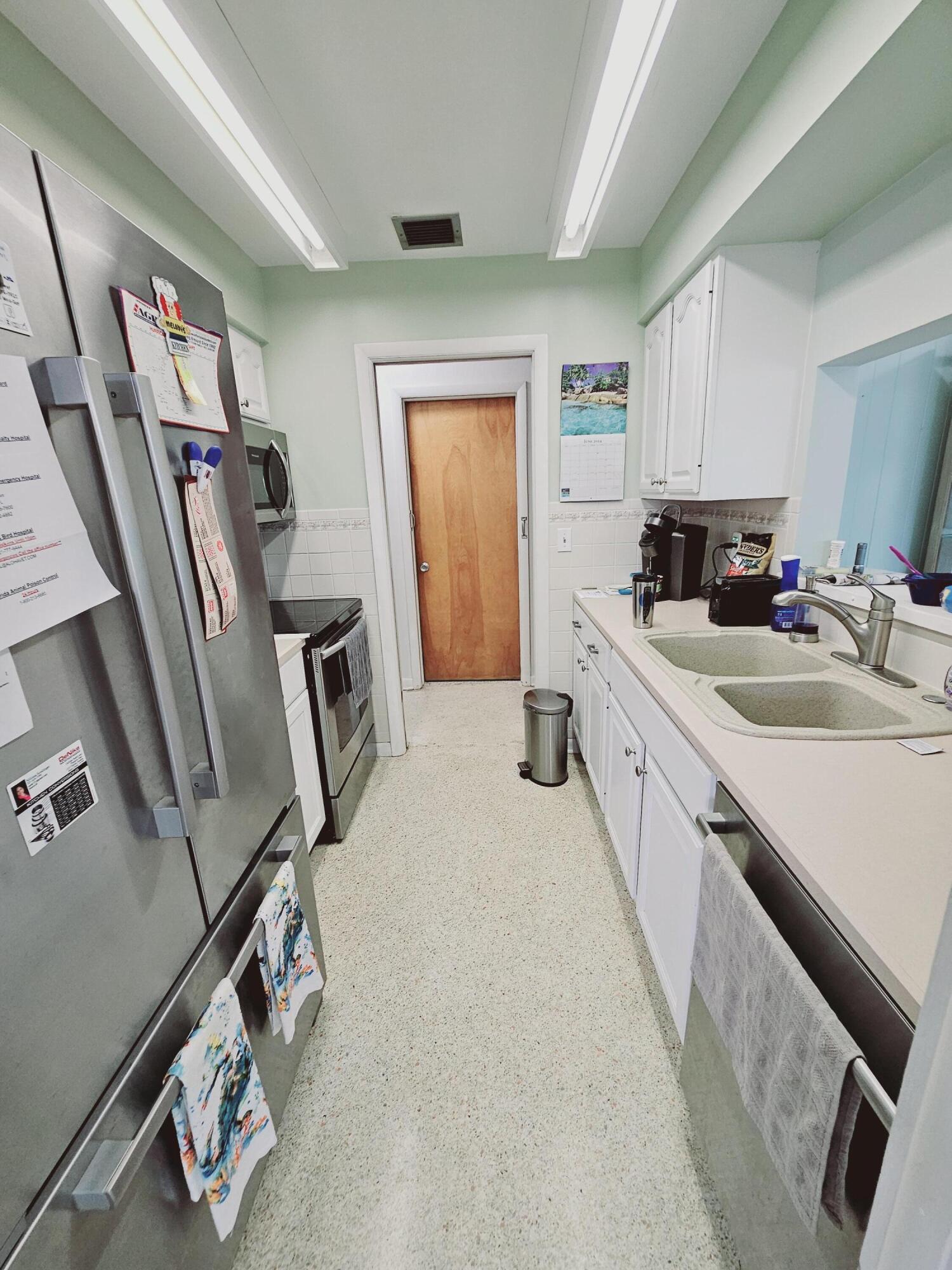 7181 Blue Shore Road Grant, FL 32949 - Photo 14 of 40 a kitchen with sink refrigerator and window