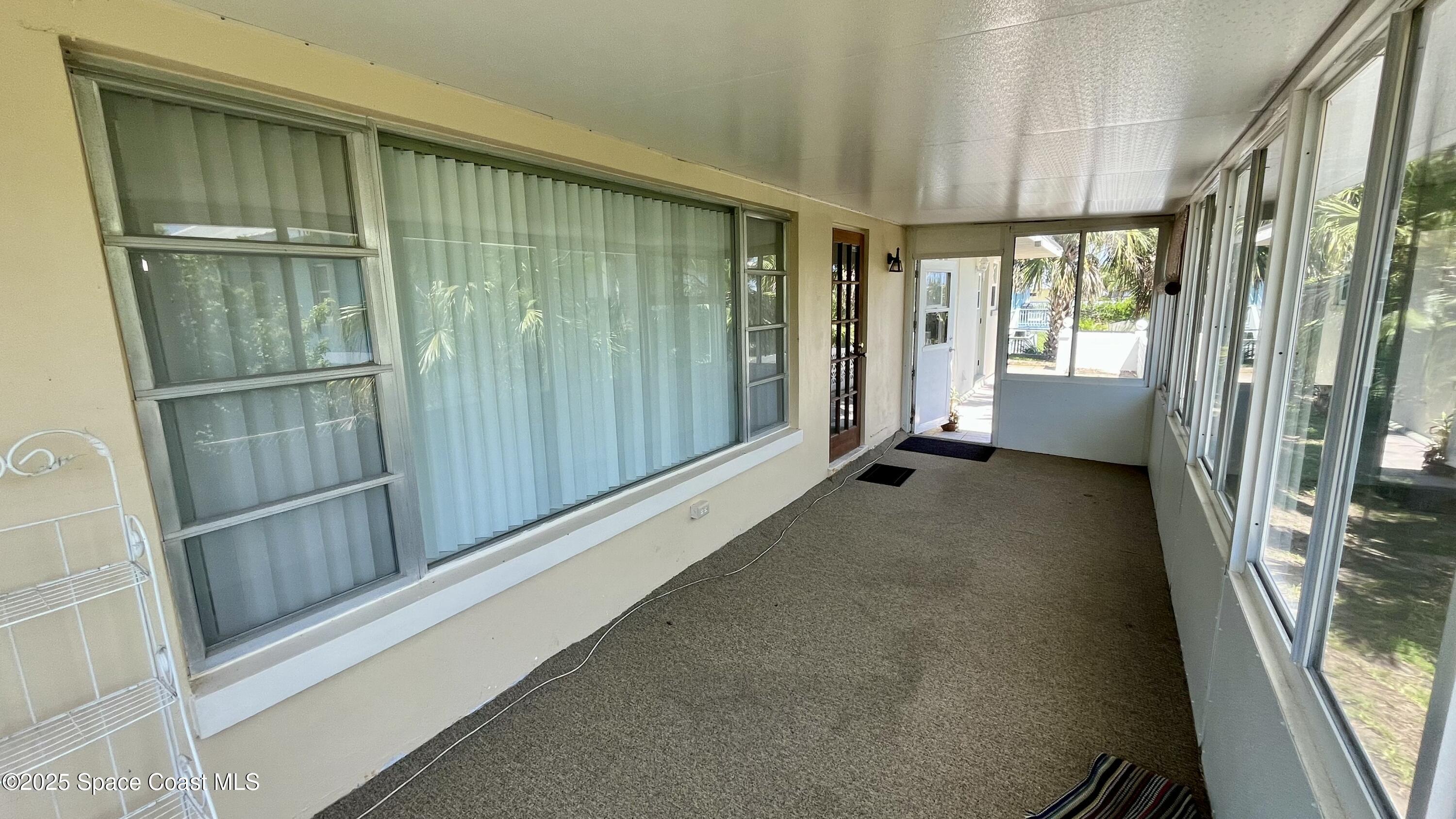 7181 Blue Shore Road Grant, FL 32949 - Photo 24 of 40 a view of a balcony with wooden floor and door