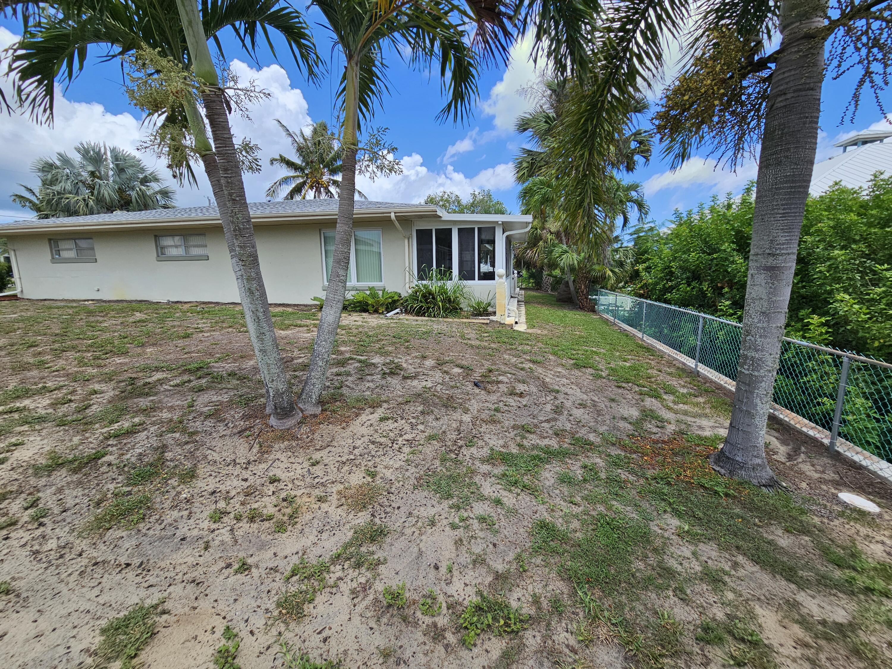 7181 Blue Shore Road Grant, FL 32949 - Photo 26 of 40 a front view of a house with garden