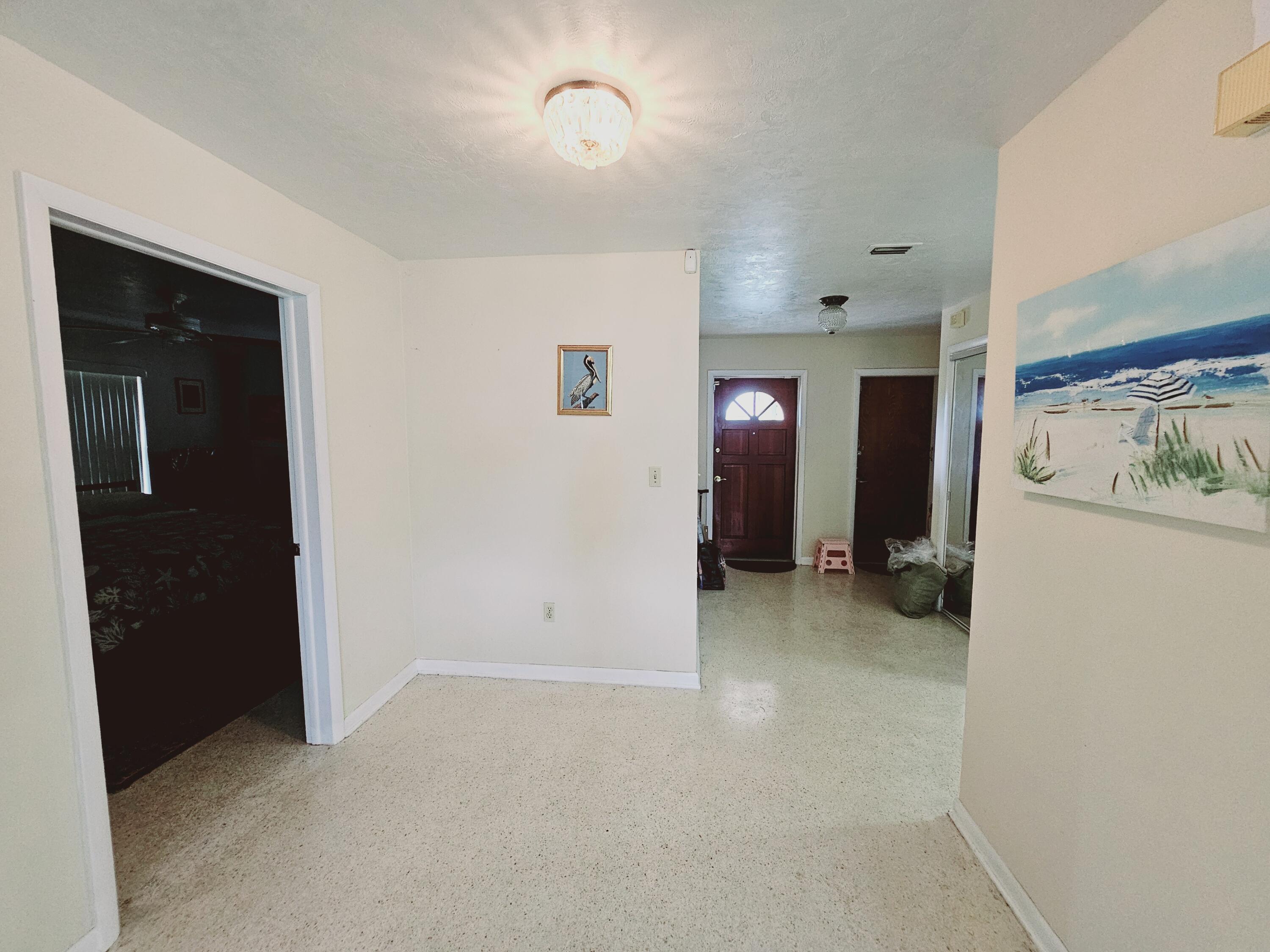7181 Blue Shore Road Grant, FL 32949 - Photo 6 of 40 en empty room with furniture and a ceiling fan