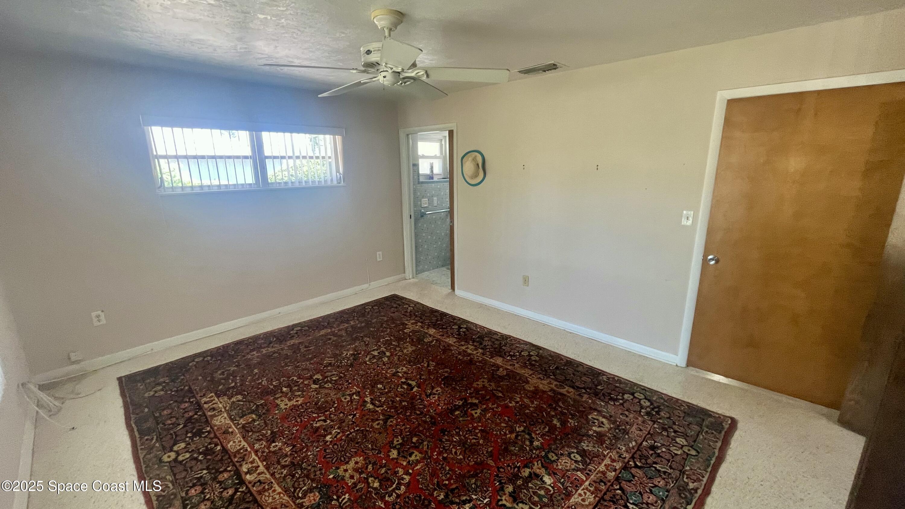 7181 Blue Shore Road Grant, FL 32949 - Photo 9 of 40 wooden floor in an empty room with a window