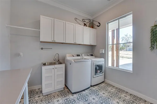 a utility room with sink dryer and washer