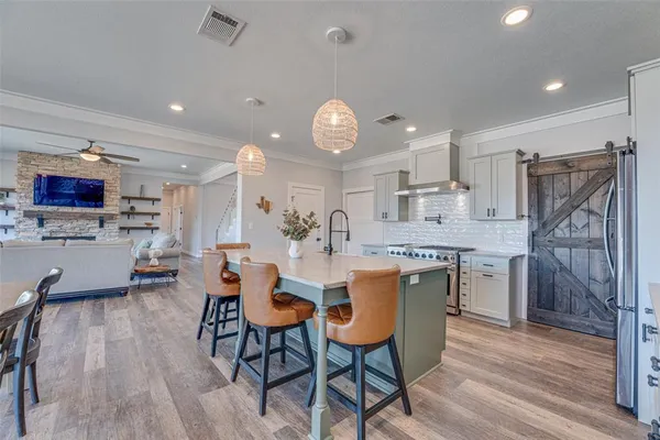 a large kitchen with a table and chairs