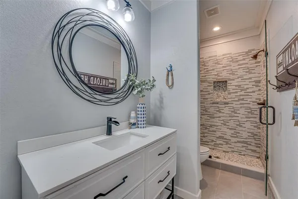a bathroom with a sink a toilet and a mirror