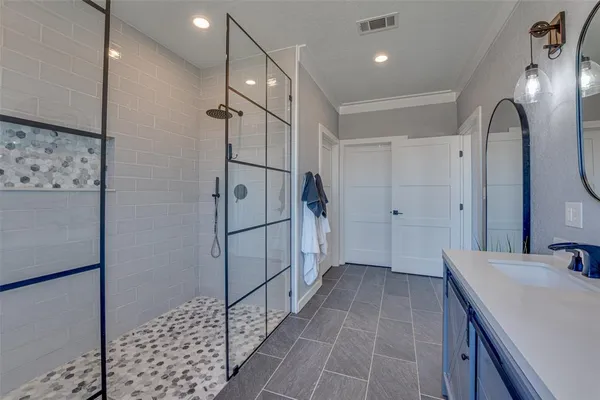 a bathroom with a shower and a sink