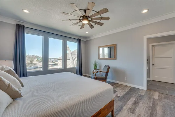 a bedroom with a large bed and a chandelier