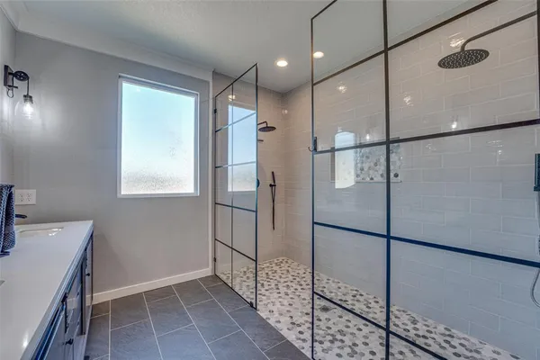 a bathroom with a shower and a sink