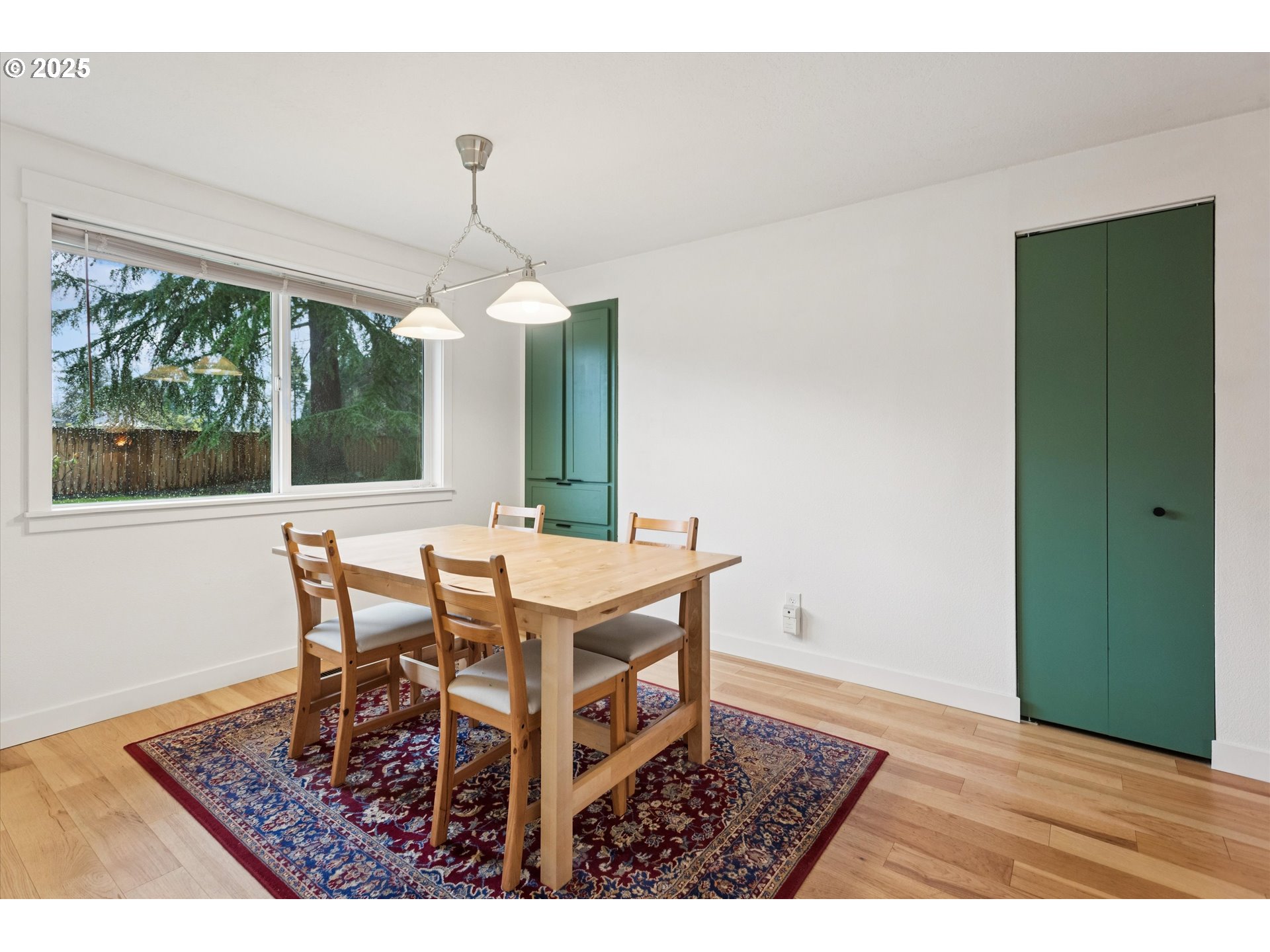 18800 Southwest Sandra Lane Beaverton, OR 97003 - Photo 12 of 41 a dining room with wooden floor a chandelier a wooden table and chairs