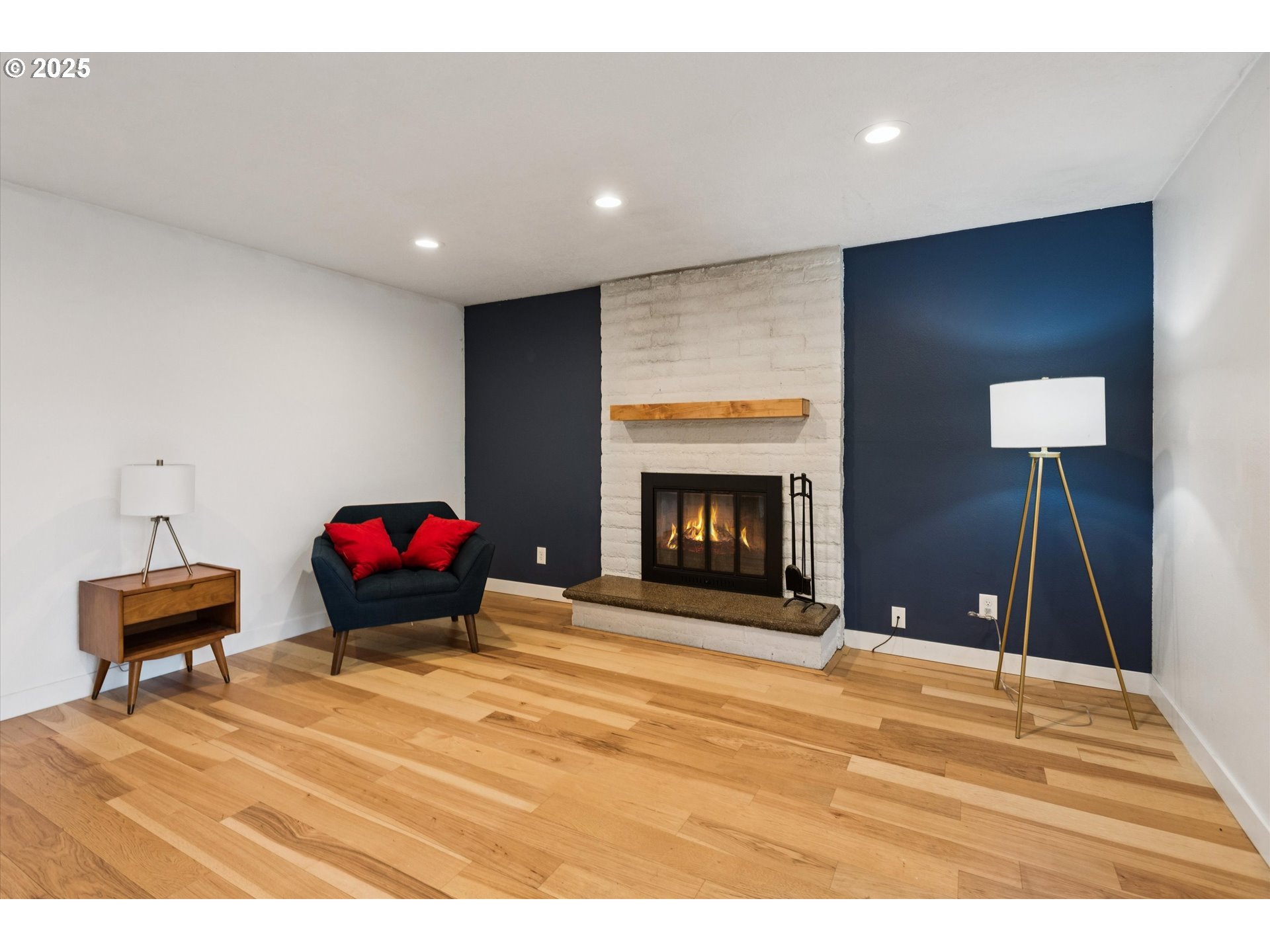 18800 Southwest Sandra Lane Beaverton, OR 97003 - Photo 20 of 41 a living room with a fireplace and a potted plant
